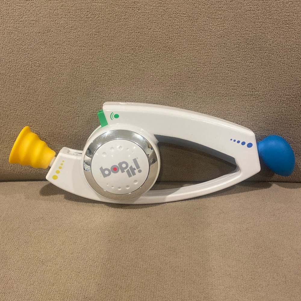 Bop it handheld game made in the 90’s great working condition white yellow blue